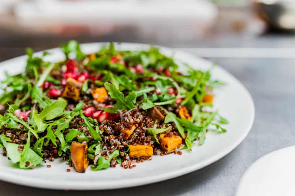 quinoa salad with arugula on plate